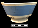 Dipped refined white earthenware London shape bowl slip banded in blue. Rim diameter: 6.00”, Vessel height:  3.50”, from 18BC27, Feature 30.